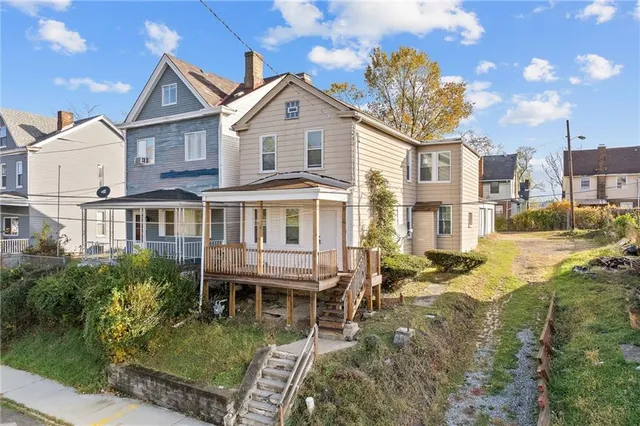 a front view of a house with a yard table and chairs
