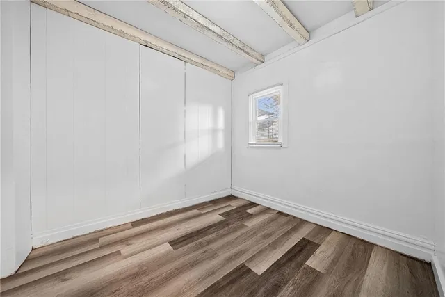 a view of room with window and hardwood floor