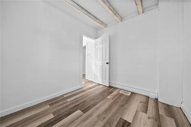 a view of room with wooden floor