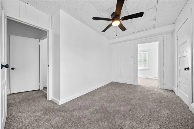 a view of a livingroom with a ceiling fan & entryway