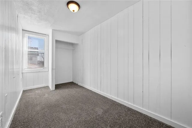 a view of an empty room and closet area