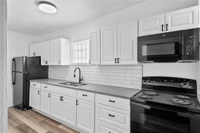 a kitchen with cabinets stainless steel appliances and a counter space