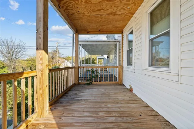a view of a balcony with wooden floor