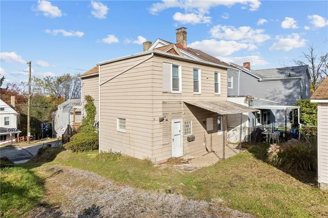 a view of a white house with a yard
