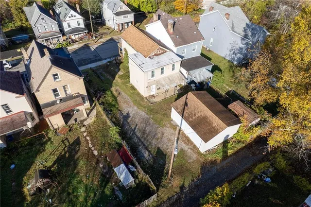 an aerial view of a house with a yard and a patio