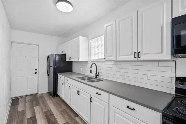 a kitchen with stainless steel appliances a sink stove and cabinets