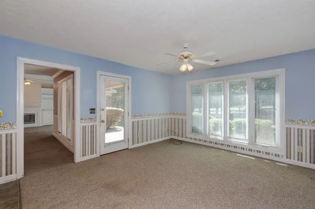 a view of an empty room with a fan