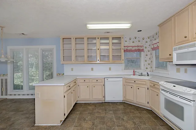 a kitchen with a sink stove and cabinets