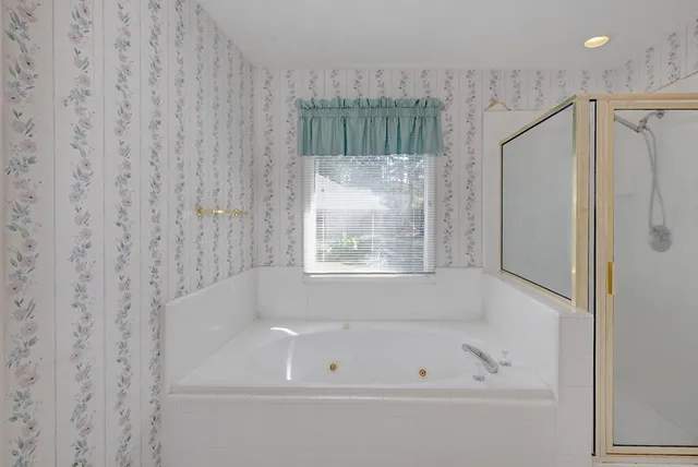 a bathroom with a bathtub and a shower