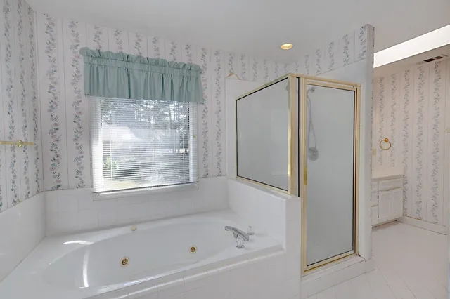 a bathroom with a bathtub and a shower