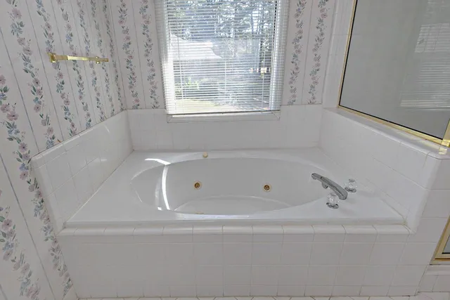 a white bath tub sitting next to a window