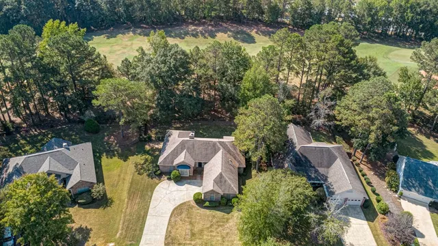 an aerial view of house with yard and swimming pool