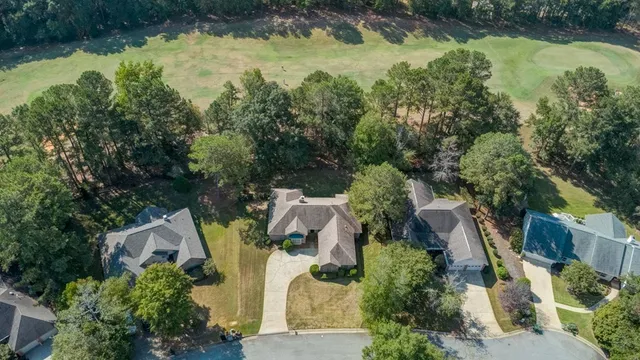 an aerial view of residential house with outdoor space and trees around