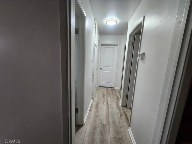 a view of a small space with wooden floor and a window