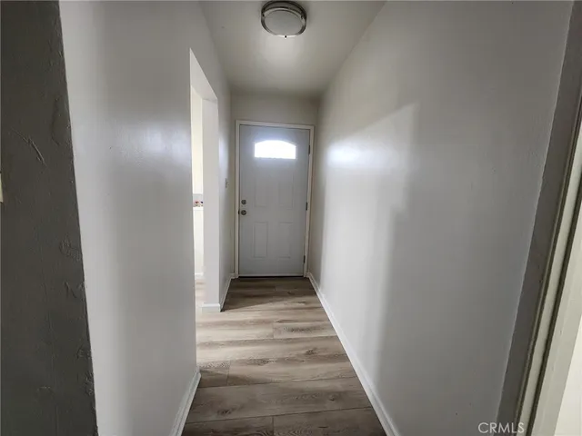 a view of a hallway with wooden floor