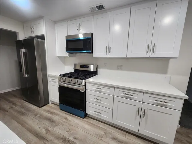 a kitchen with sink cabinets and utility