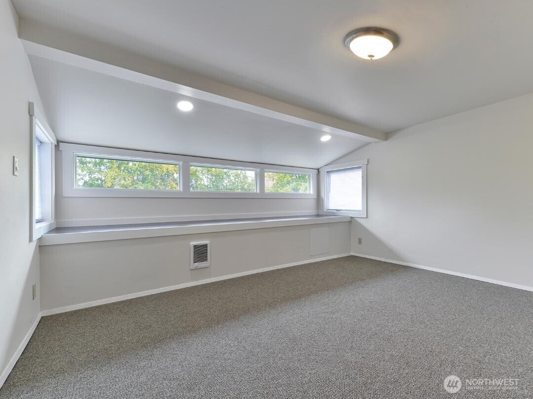 7519 Greenwood Avenue North, Unit 4 Seattle, WA 98103 - Photo 11 of 13 an empty room with windows