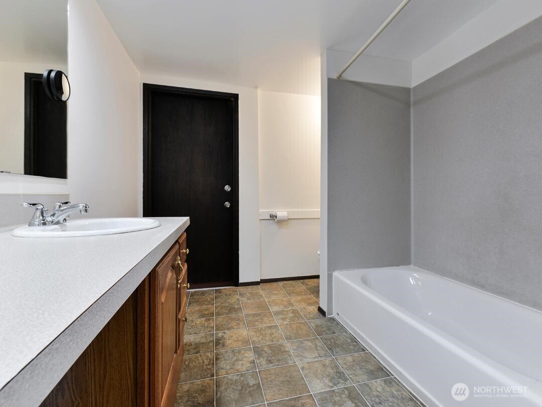 7519 Greenwood Avenue North, Unit 4 Seattle, WA 98103 - Photo 4 of 13 a bathroom with a bathtub and a sink