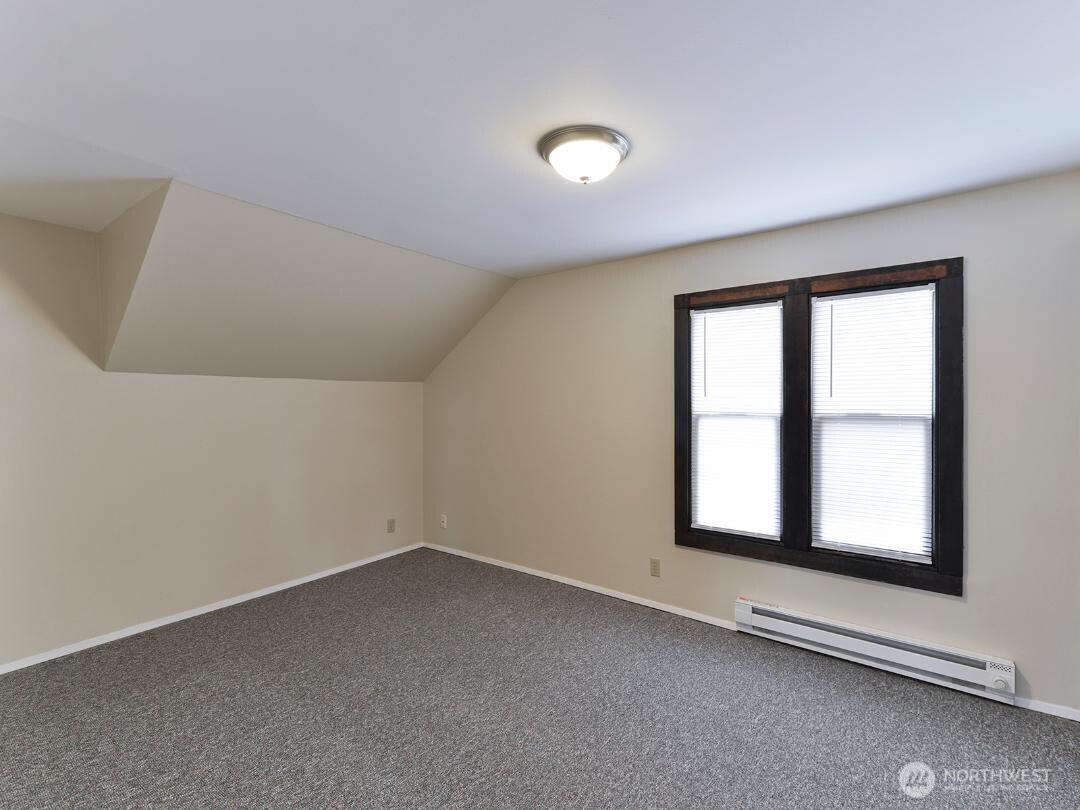 7519 Greenwood Avenue North, Unit 4 Seattle, WA 98103 - Photo 6 of 13 an empty room with a window