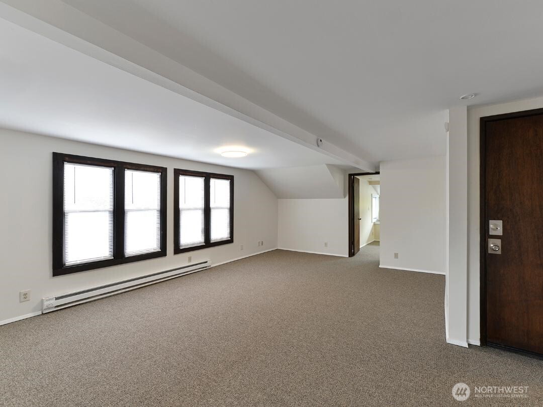 7519 Greenwood Avenue North, Unit 4 Seattle, WA 98103 - Photo 8 of 13 a view of an empty room with a window