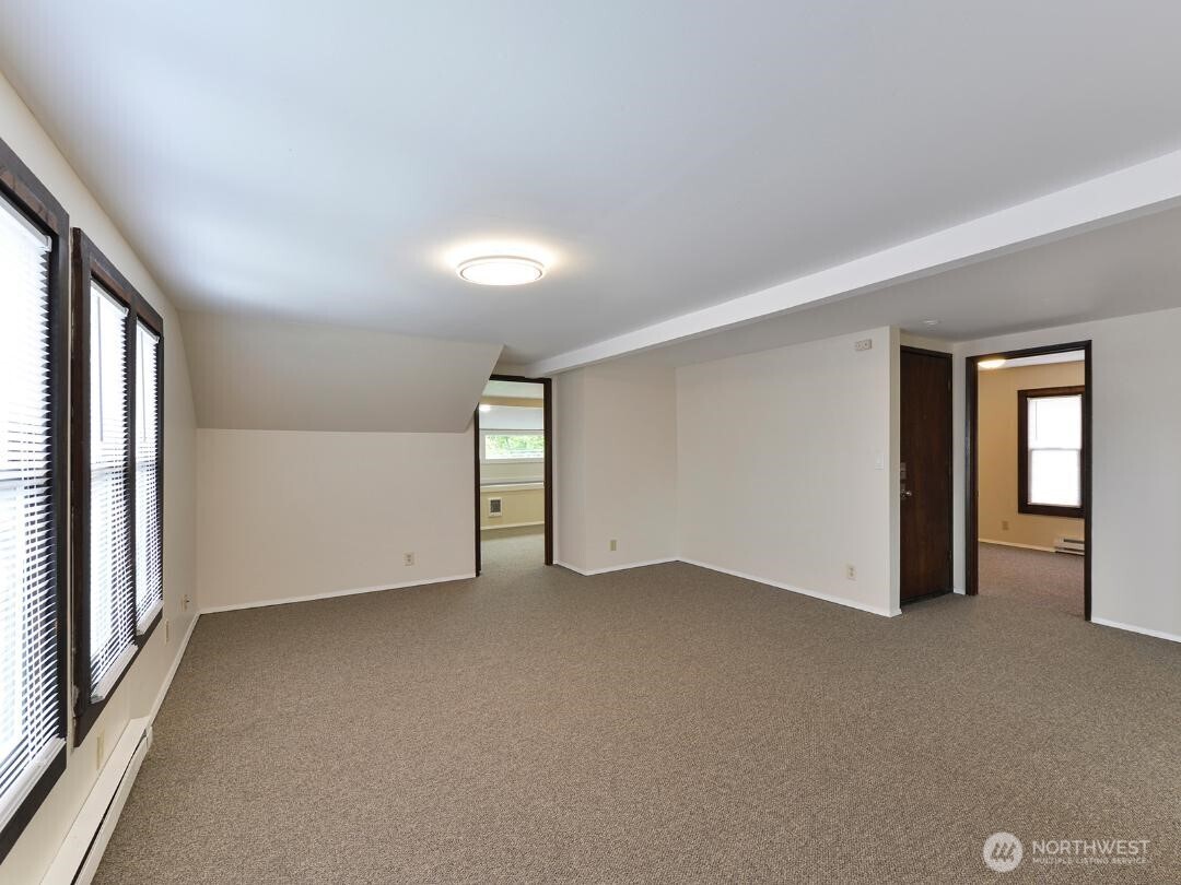7519 Greenwood Avenue North, Unit 4 Seattle, WA 98103 - Photo 9 of 13 a view of an empty room with a window