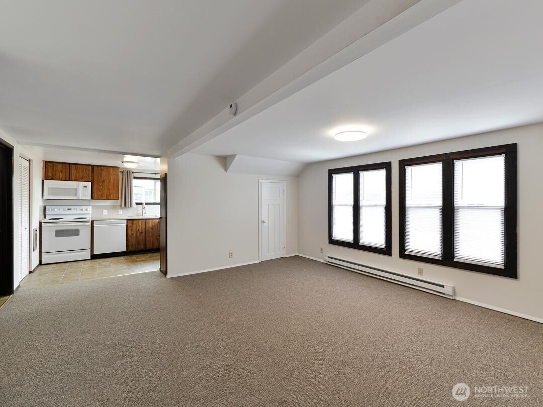 7519 Greenwood Avenue North, Unit 4 Seattle, WA 98103 - Photo 10 of 13 a view of an empty room with a window