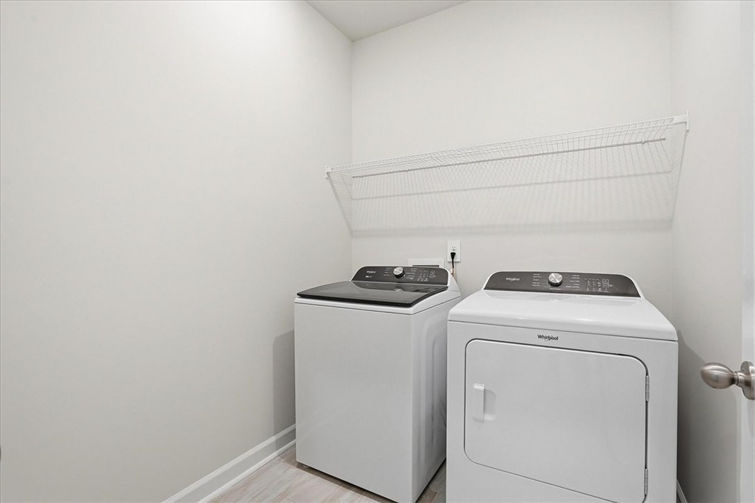 973 Penfold Pointe Point Blythewood, SC 29016 - Photo 7 of 39 This dedicated laundry space offers practical convenience with essential appliances.