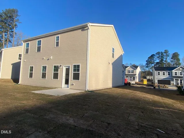 a front view of a house with a street