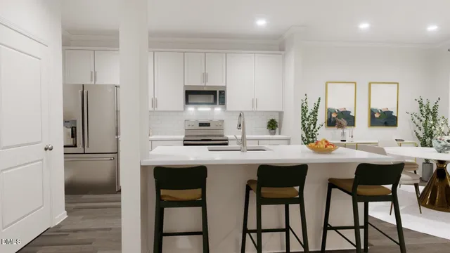 a kitchen with appliances a sink and cabinets