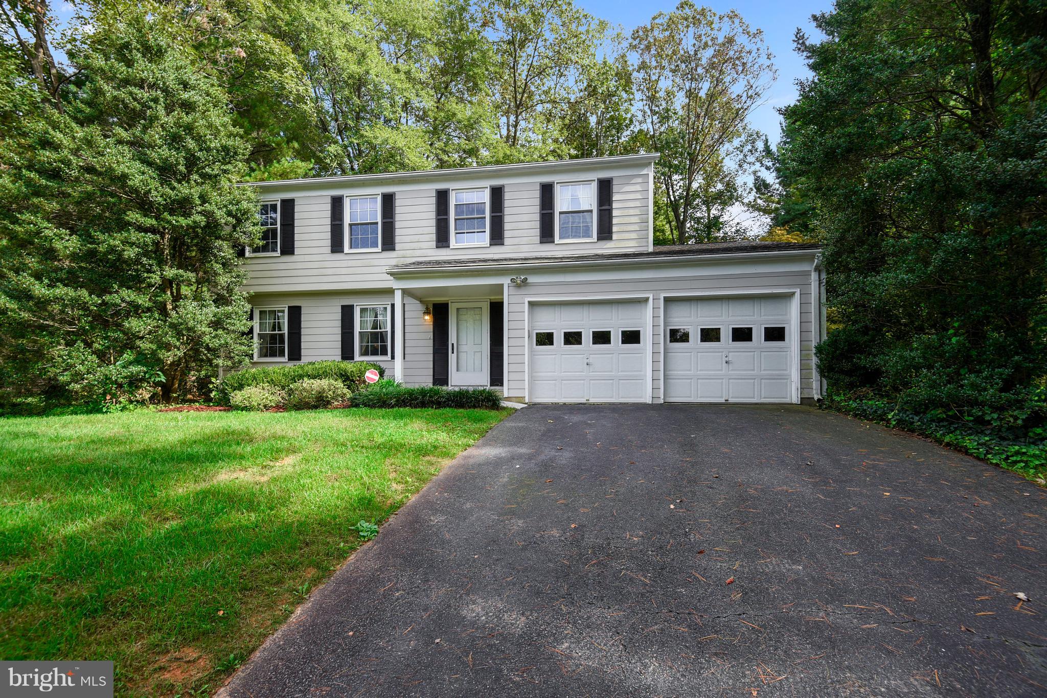 11003 Howland Drive Reston, VA 20191 - Photo 1 of 21 a front view of a house with a yard and garage