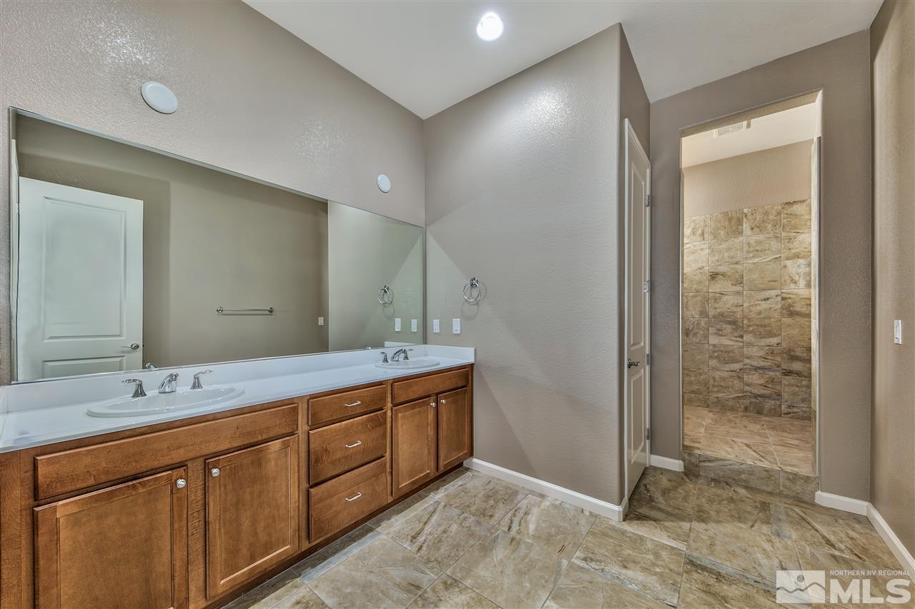 2109 Gregorgio Ln. Reno, NV 89521 - Photo 15 of 38 a spacious bathroom with a shower sink and mirror