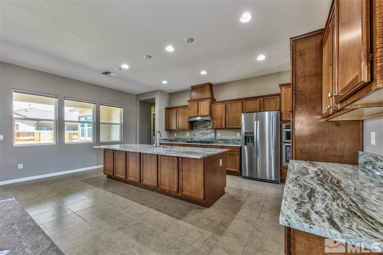 2109 Gregorgio Ln. Reno, NV 89521 - Photo 2 of 38 a large kitchen with stainless steel appliances granite countertop a refrigerator and a stove