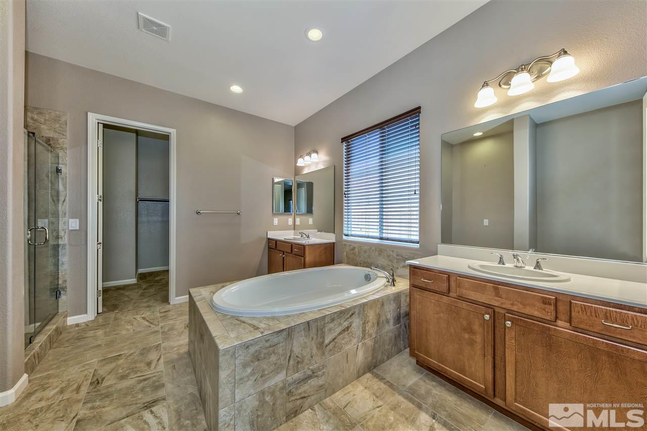 2109 Gregorgio Ln. Reno, NV 89521 - Photo 4 of 38 a bathroom with a tub a sink and mirror