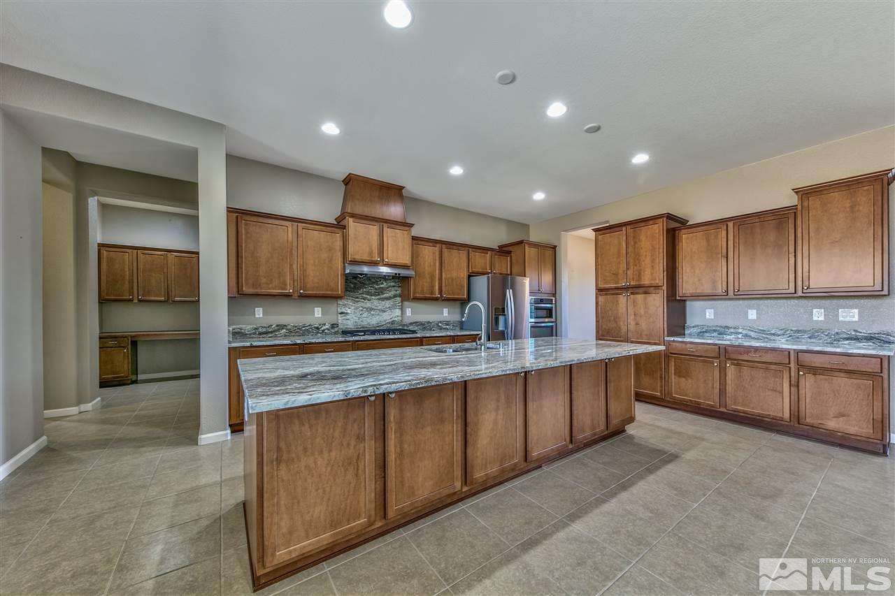 2109 Gregorgio Ln. Reno, NV 89521 - Photo 9 of 38 a large kitchen with kitchen island a sink stainless steel appliances and cabinets