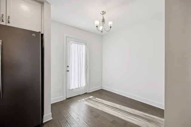 a view of wooden floor and windows in a room