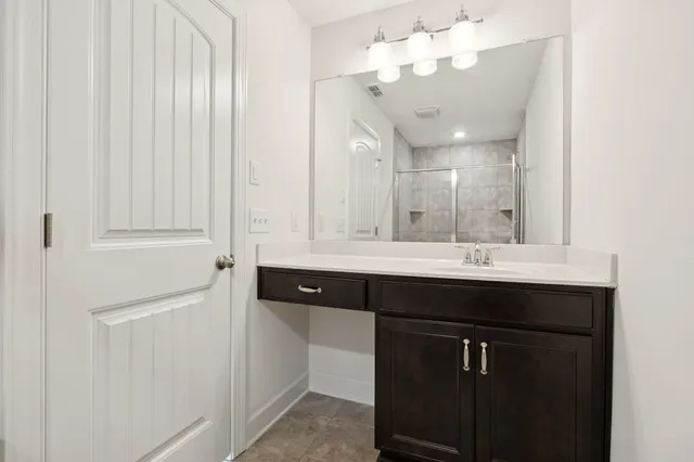 a bathroom with a sink vanity and a mirror