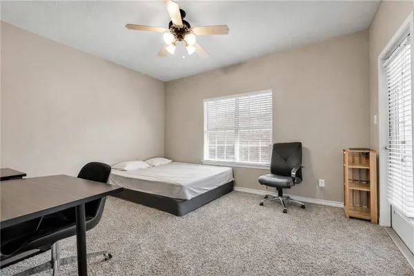 a bedroom with furniture and a window