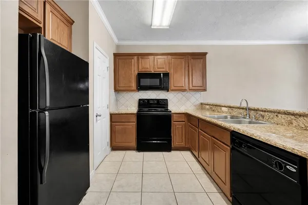a kitchen with a refrigerator and a stove top oven