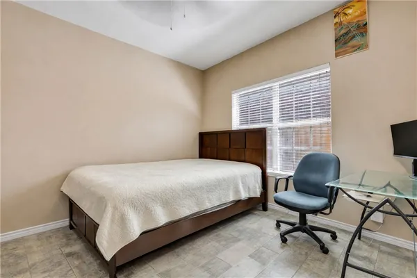 a bedroom with a bed chair and window