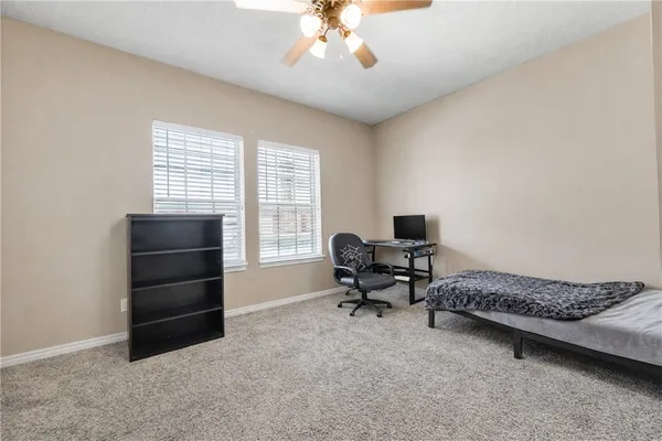 a bedroom with a bed and a desk