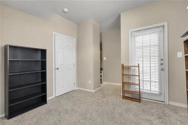 a view of an empty room with a closet