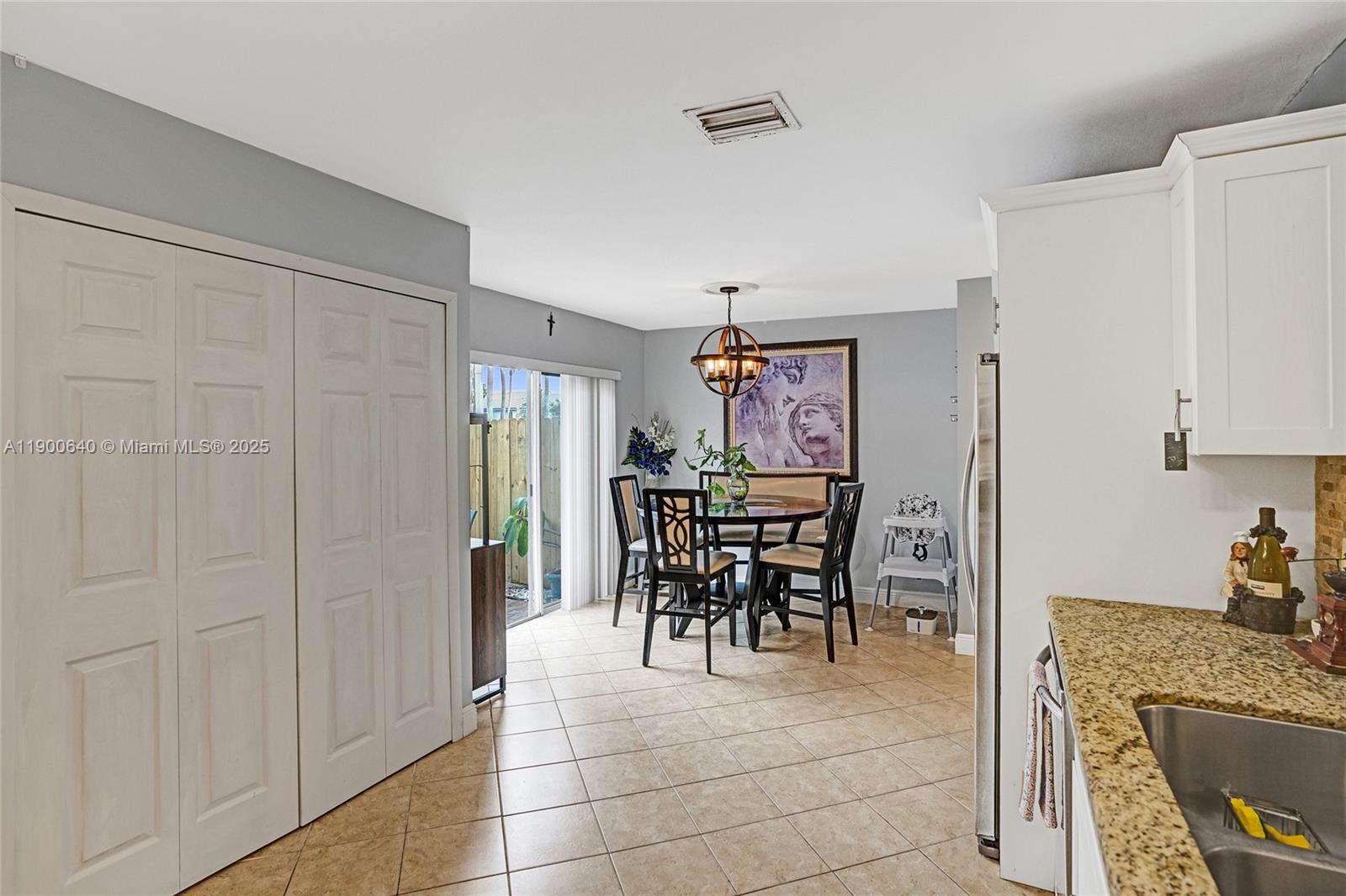 12221 Southwest 144th Terrace Miami, FL 33186 - Photo 13 of 42 a dining room filled with furniture and a refrigerator