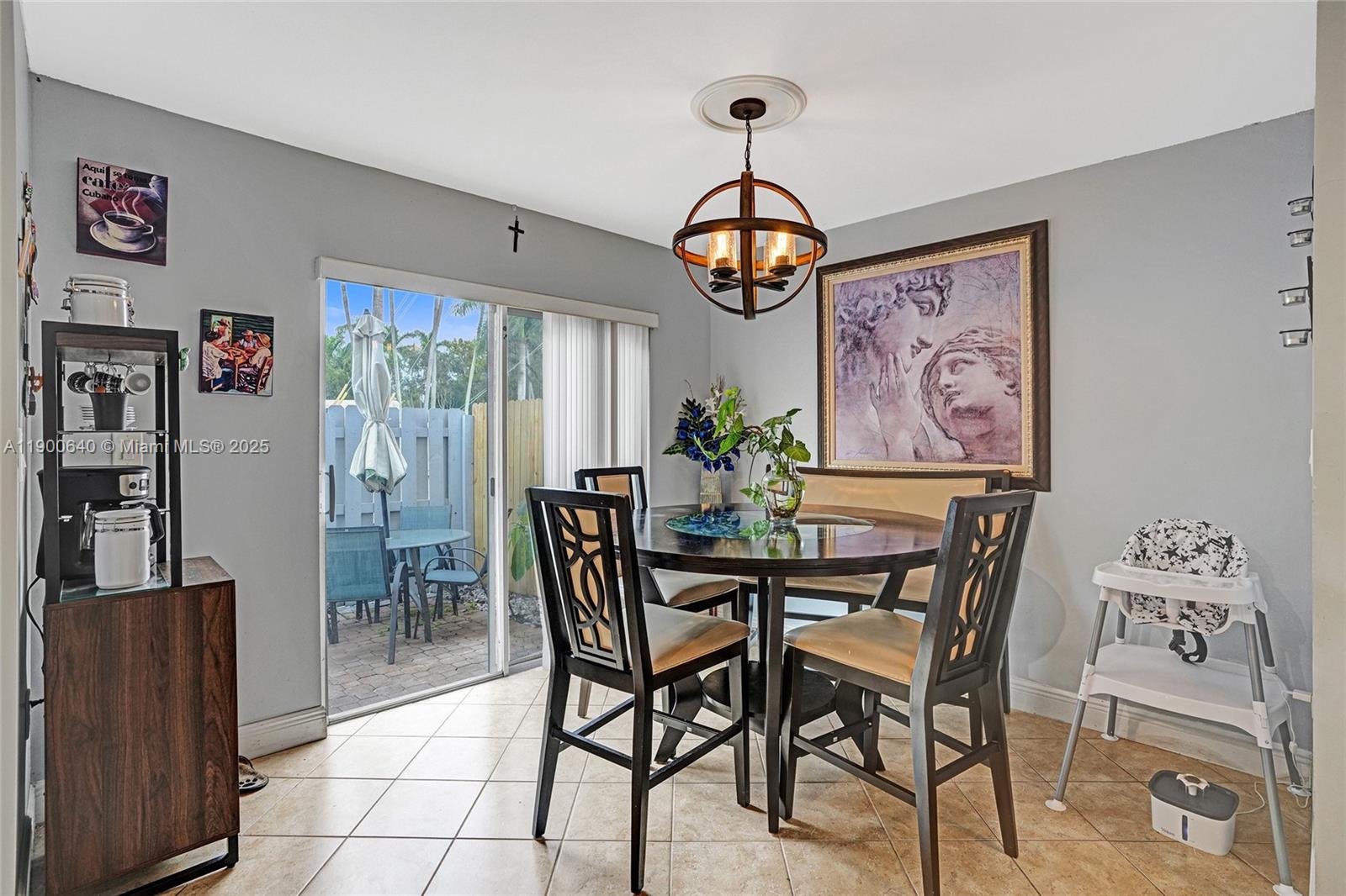 12221 Southwest 144th Terrace Miami, FL 33186 - Photo 15 of 42 a view of a dining room with furniture wooden floor and a chandelier