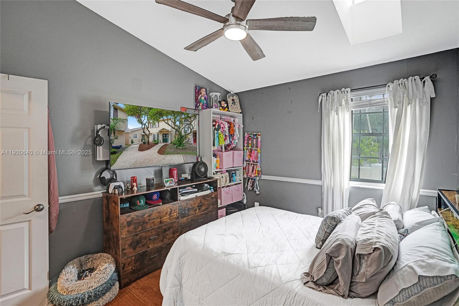 12221 Southwest 144th Terrace Miami, FL 33186 - Photo 18 of 42 a bedroom with a bed and a flat tv screen on dresser
