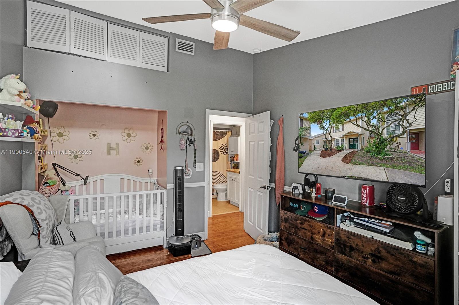 12221 Southwest 144th Terrace Miami, FL 33186 - Photo 19 of 42 a bedroom with furniture and a flat screen tv