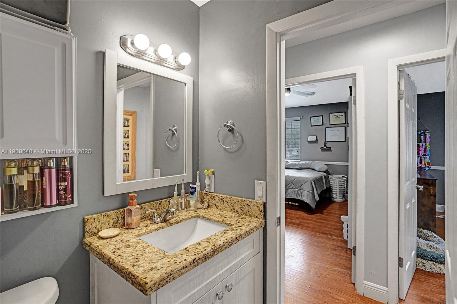 12221 Southwest 144th Terrace Miami, FL 33186 - Photo 22 of 42 a en suite bathroom with a granite countertop sink and a mirror