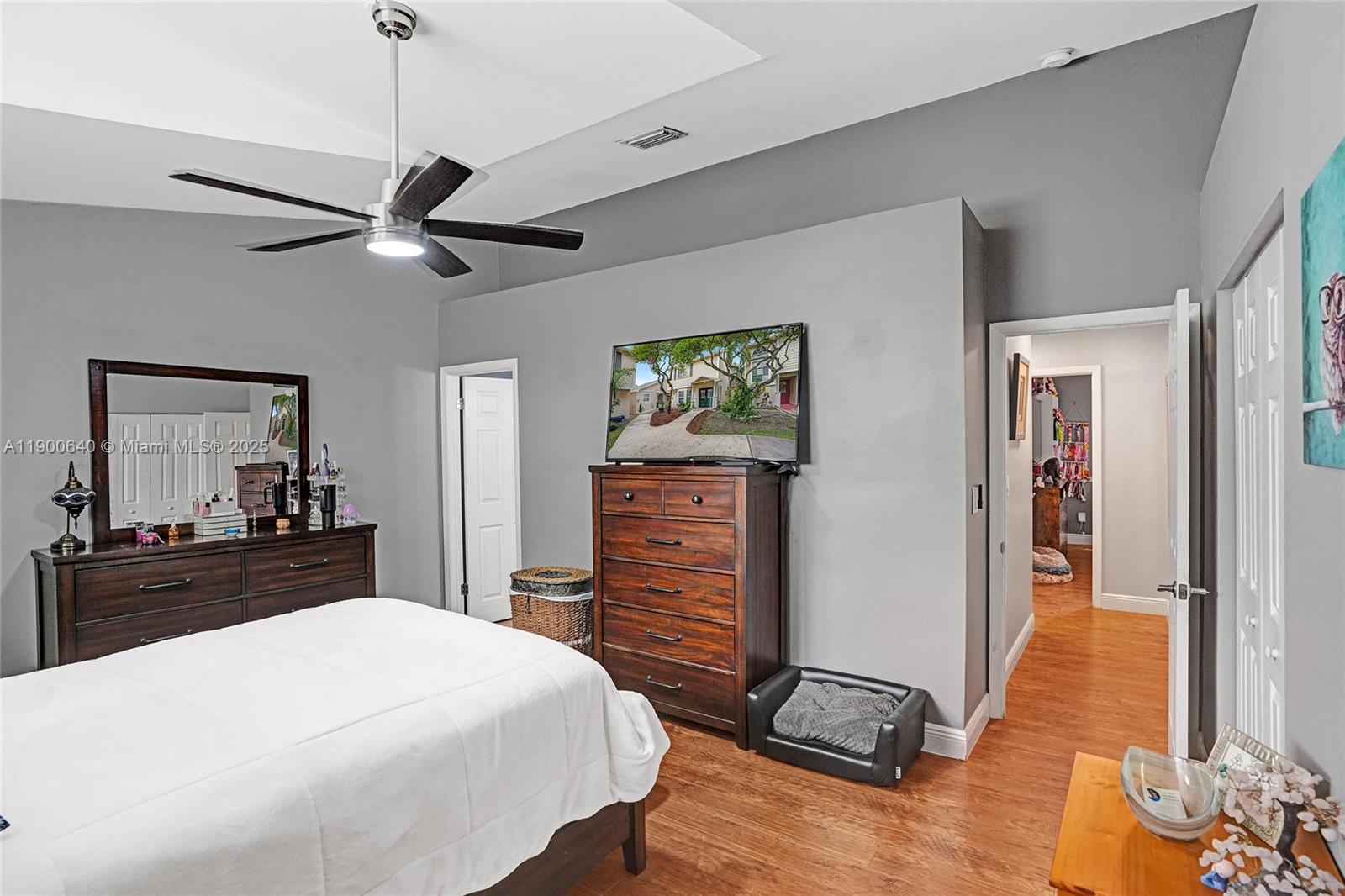 12221 Southwest 144th Terrace Miami, FL 33186 - Photo 27 of 42 a bedroom with a bed and wooden floor