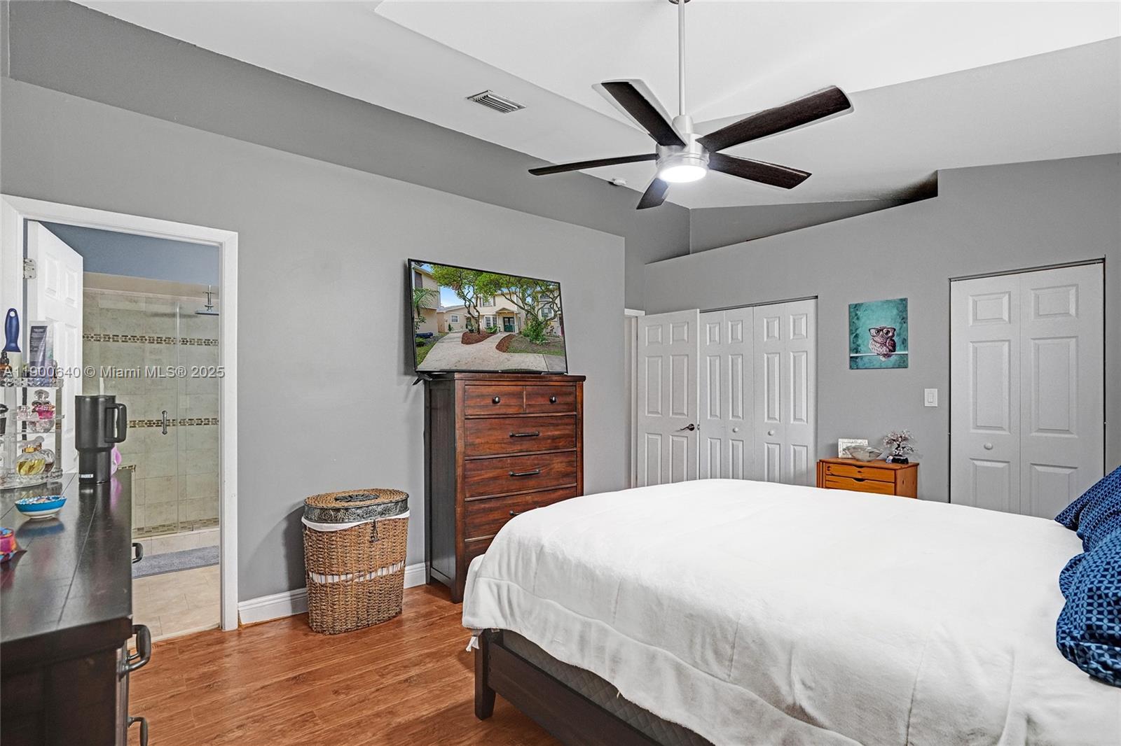 12221 Southwest 144th Terrace Miami, FL 33186 - Photo 28 of 42 a bedroom with a large bed and a chandelier