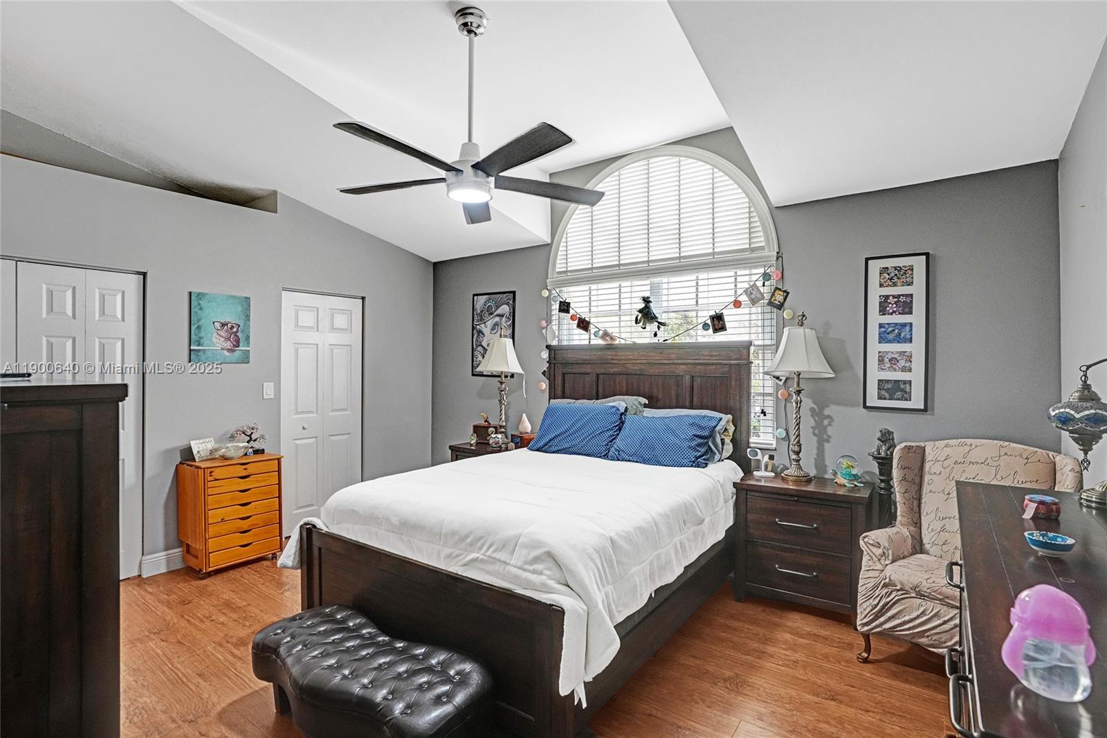 12221 Southwest 144th Terrace Miami, FL 33186 - Photo 29 of 42 a bedroom with a bed chandelier and a window