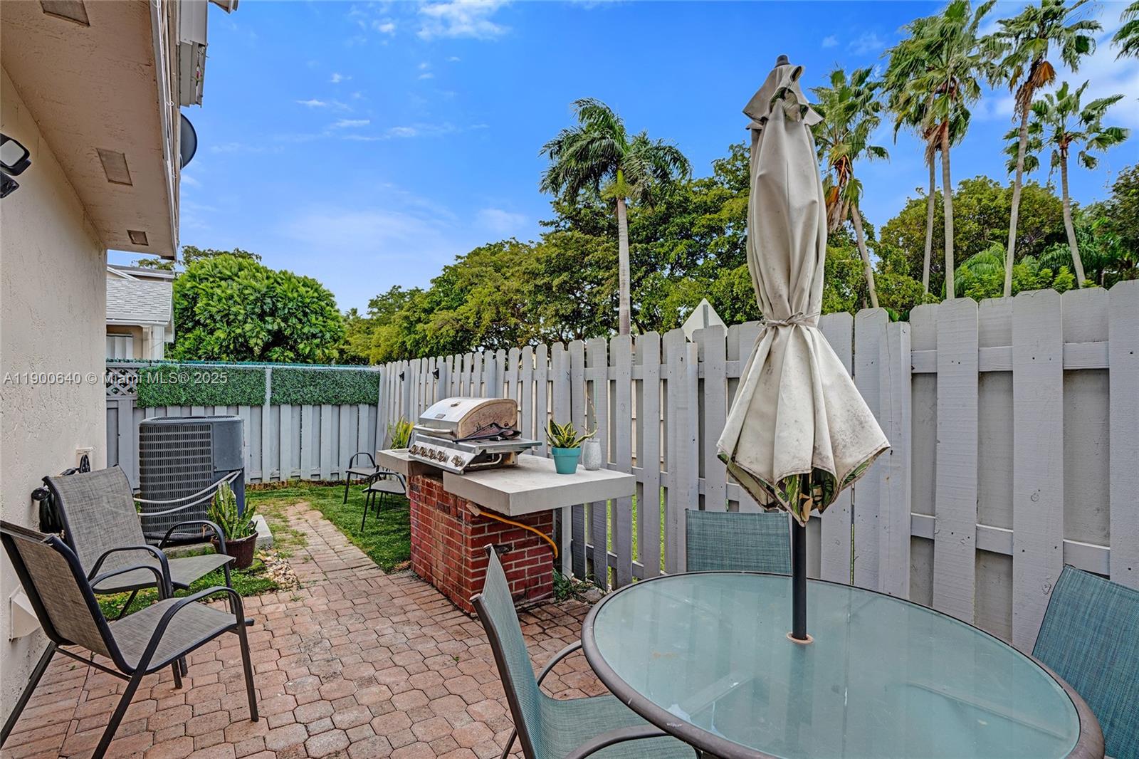 12221 Southwest 144th Terrace Miami, FL 33186 - Photo 33 of 42 a backyard of a house with table and chairs